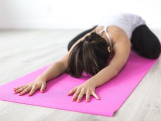 Woman on the floor doing Yoga