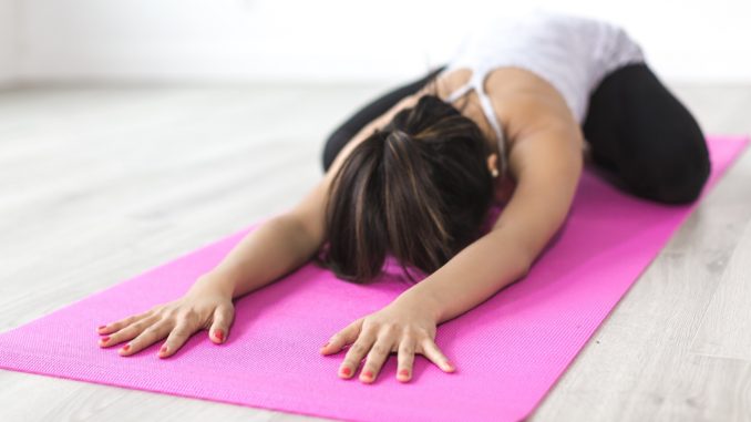 Woman on the floor doing Yoga