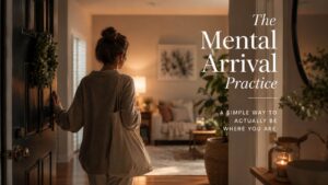 A woman pauses at the doorway of a warm, softly lit home, symbolizing the Mental Arrival Practice and the quiet moment when the mind catches up with the body.